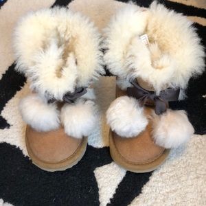 Girls Ugg Gita boots with pom poms